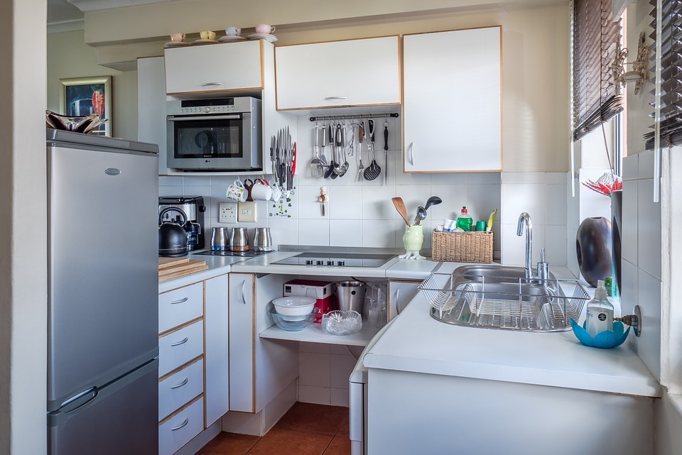 A microwave in the kitchen fitted into a cabinet