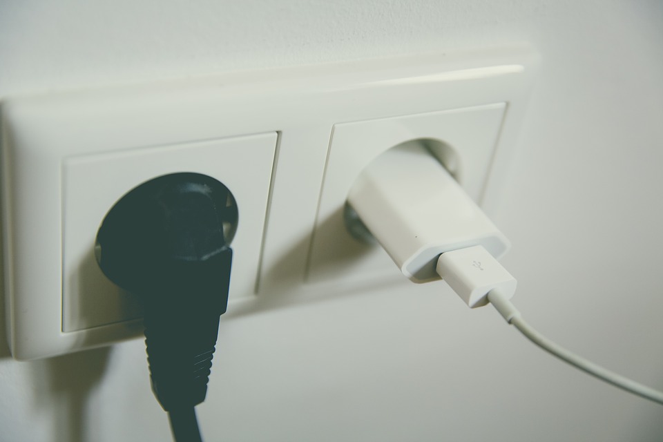 Two power sockets with plugs inserted in them