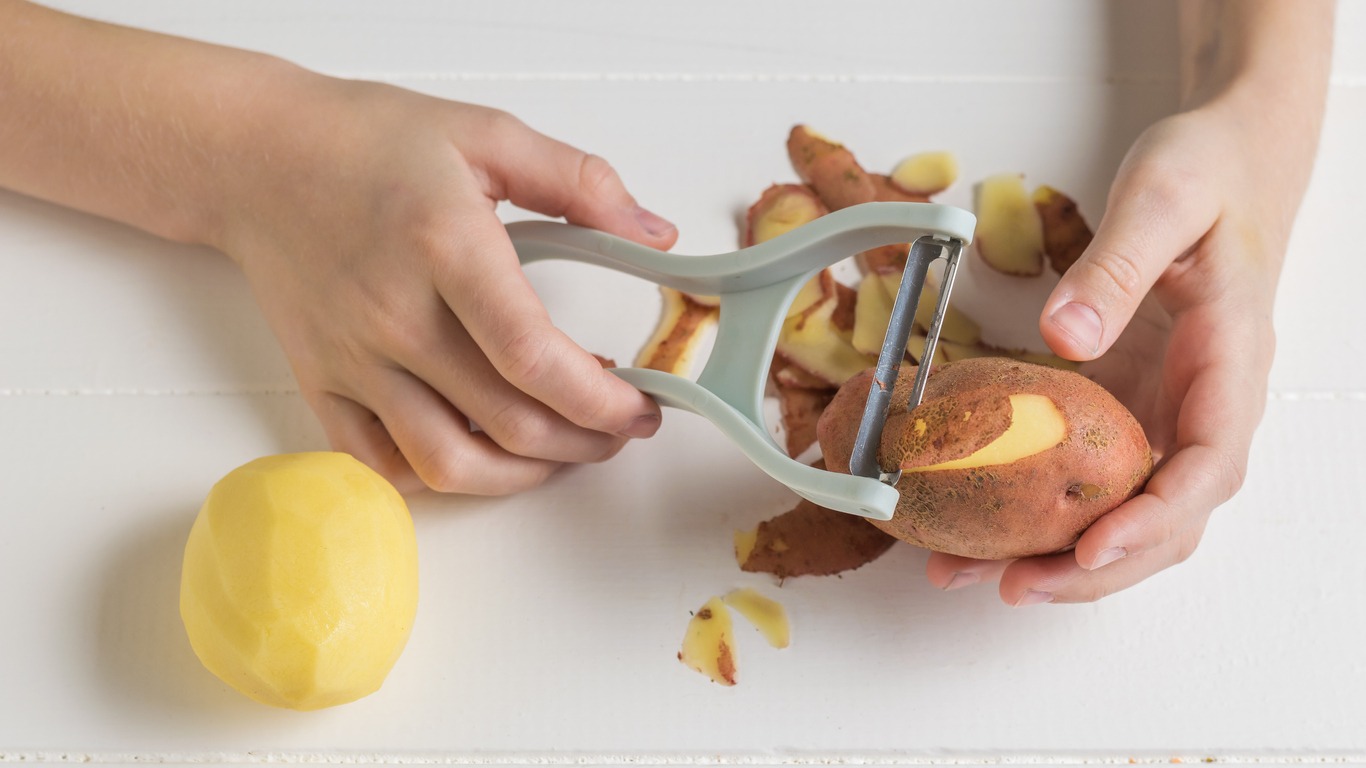 The process of preparing potatoes for cooking.