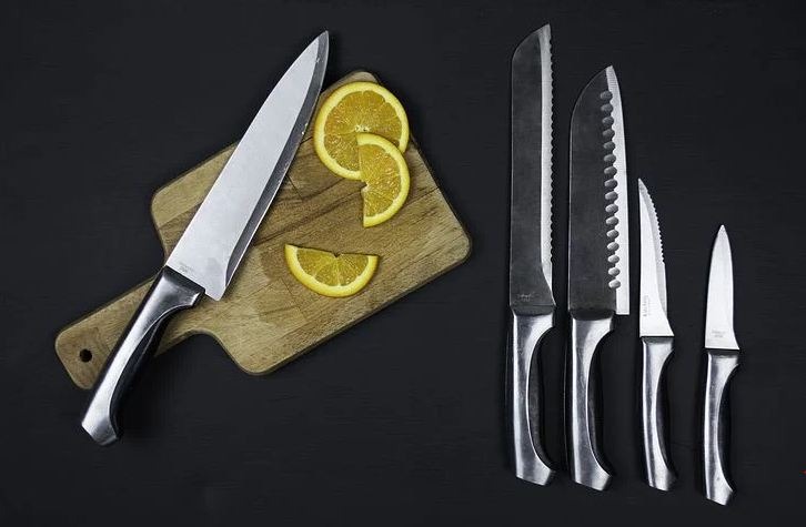 A set of kitchen knives with a chopping board