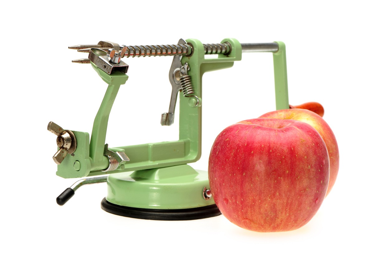 A green mechanical apple peeler
