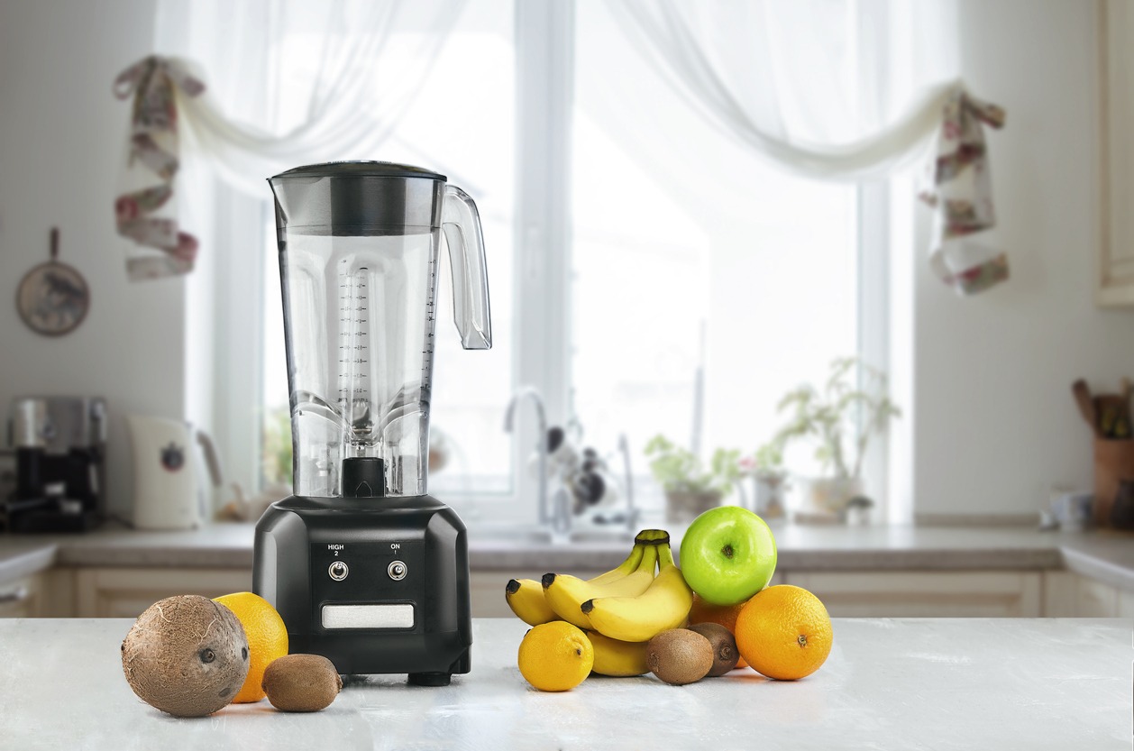 Blender and fruits on kitchen space